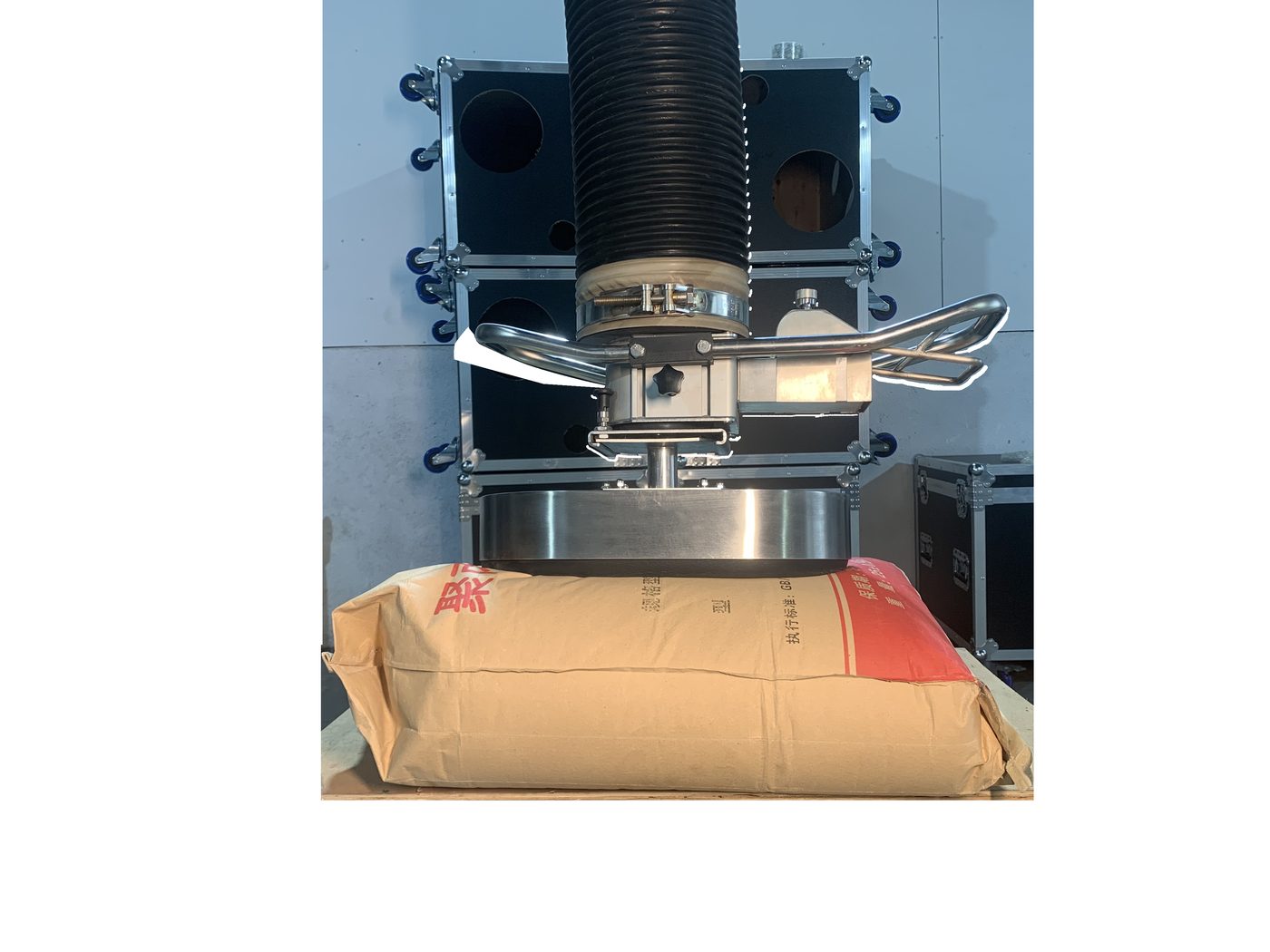 ESL-SG vacuum tube lifter lifting a paper sack off the bench