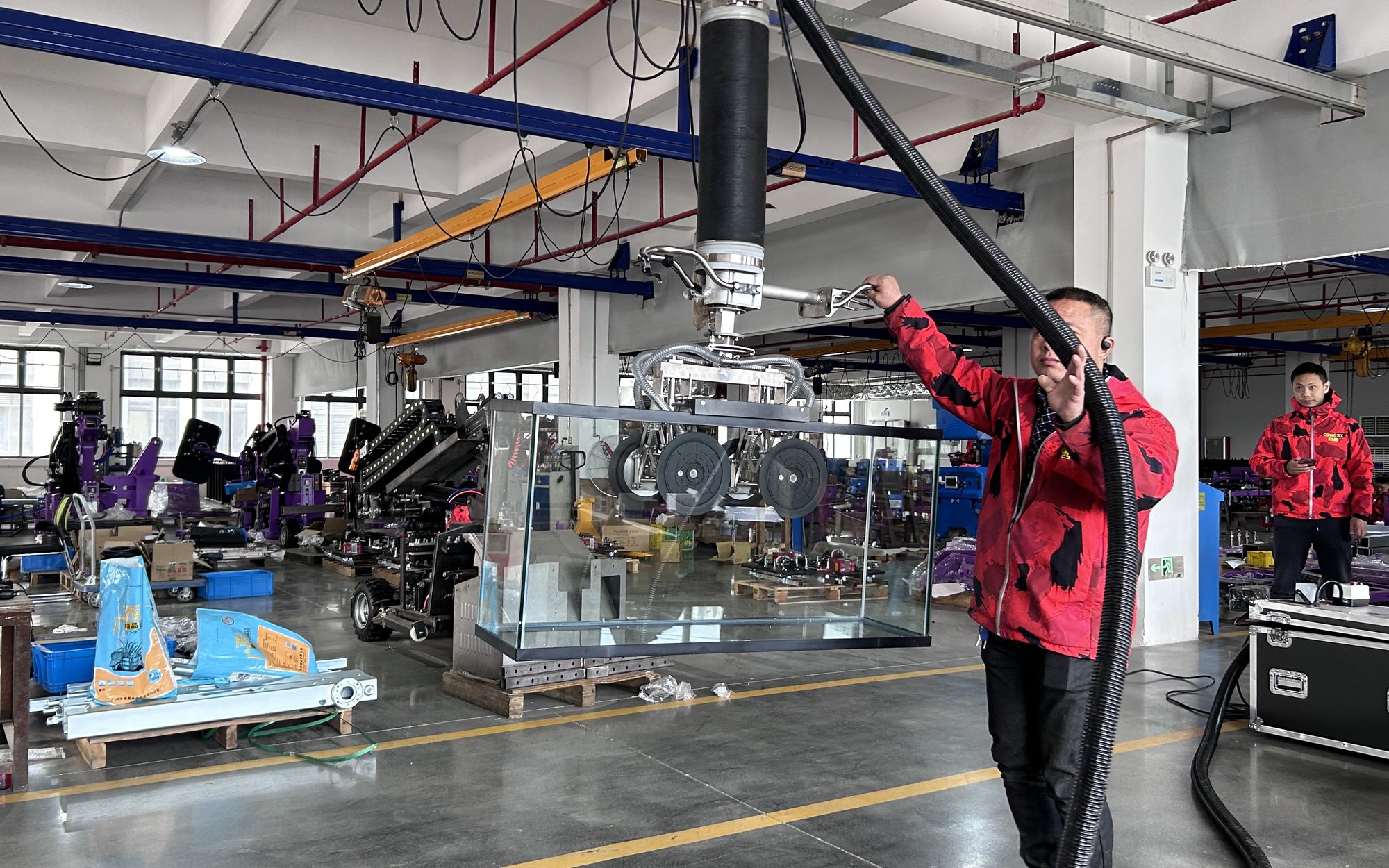 Cowest workshop floor with a vacuum tube lifter on a rail