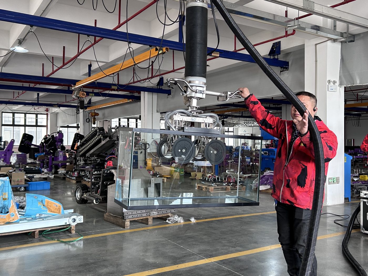 Cowest workshop floor with a vacuum tube lifter on a rail